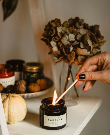 Autumn home decor featuring candles, dried flowers, and warm tones
