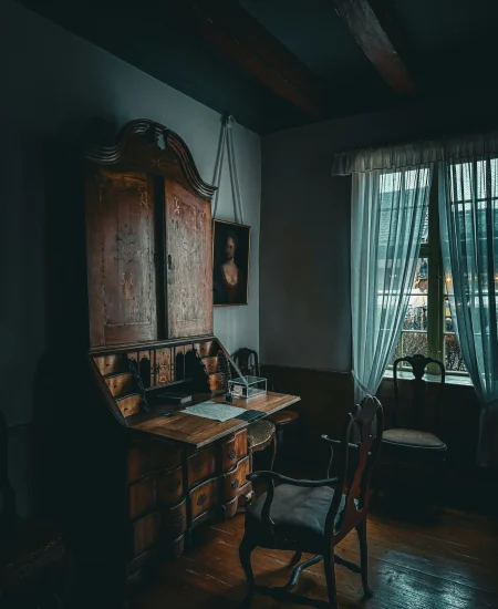 Gothic bedroom with dark walls, velvet bedding, and candlelight ambiance