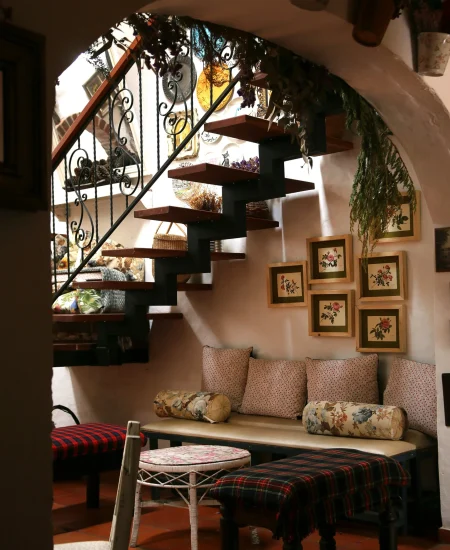 Staircase decorated with gothic candles, black garlands, and moody lighting