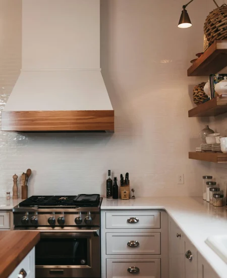 Minimalist kitchen with open shelving, neutral colors, and natural light