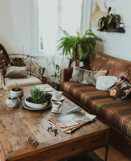 Vintage-inspired living room with patterned sofa, antique mirror, and cozy lighting